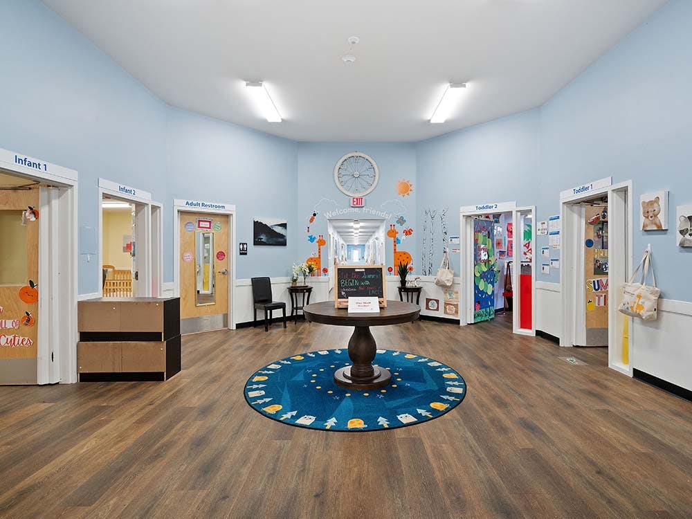 Classroom hallway with doors labeled Infant 1, Infant 2, Adult Restroom, Toddler 2, Toddler 1