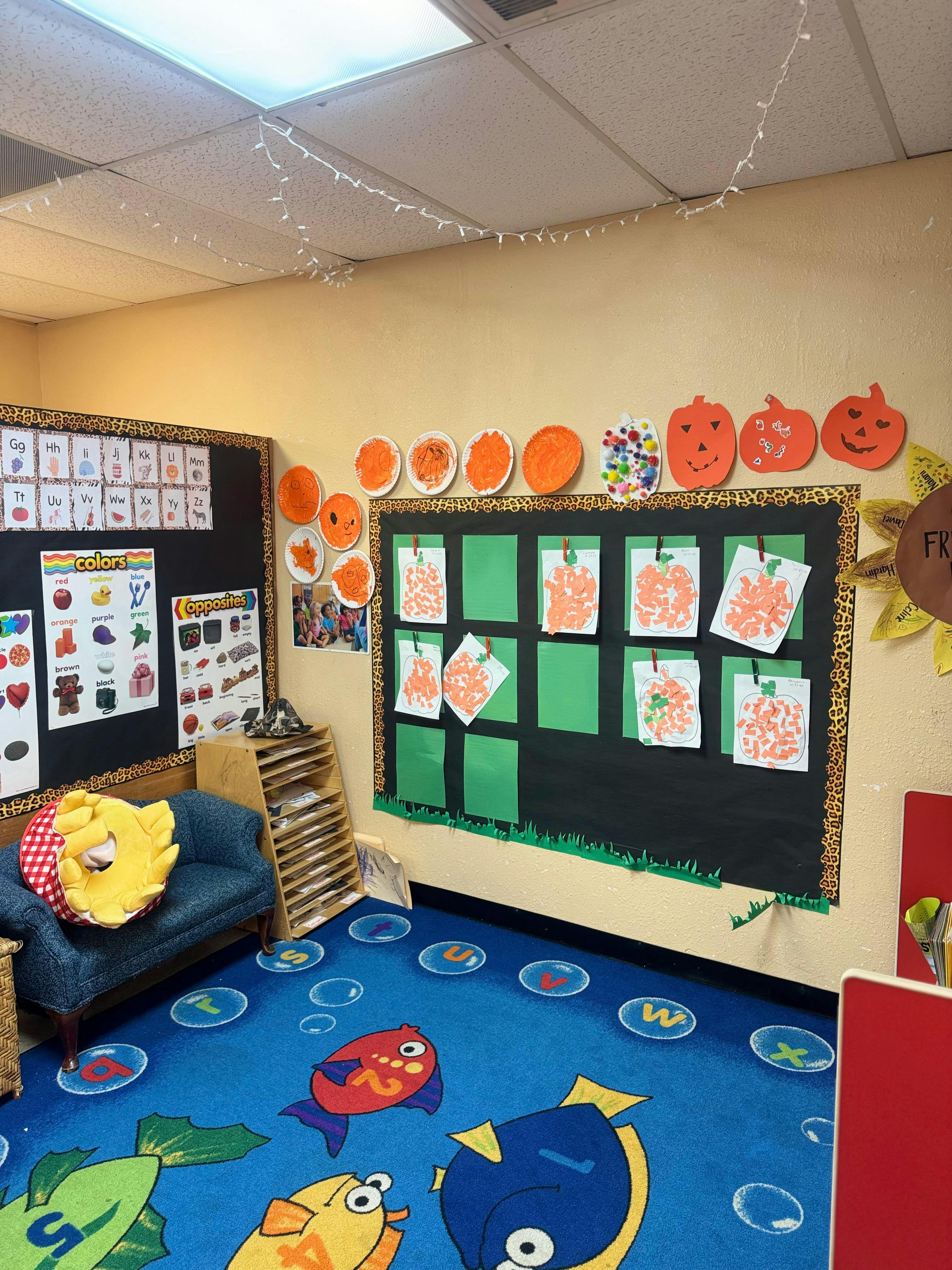 Classroom wall decorated with pumpkin crafts and educational posters