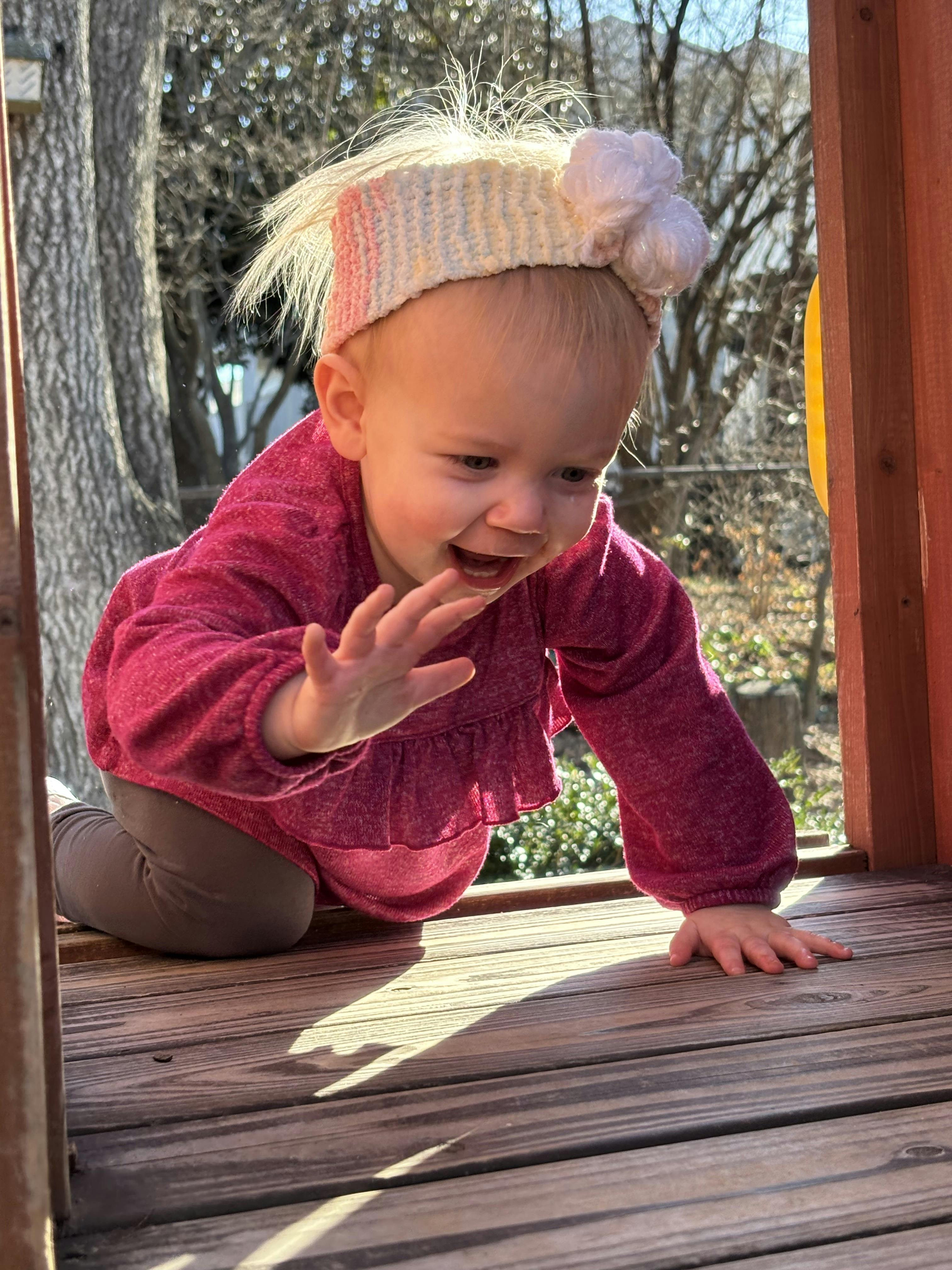 Child crawling on a wooden surface