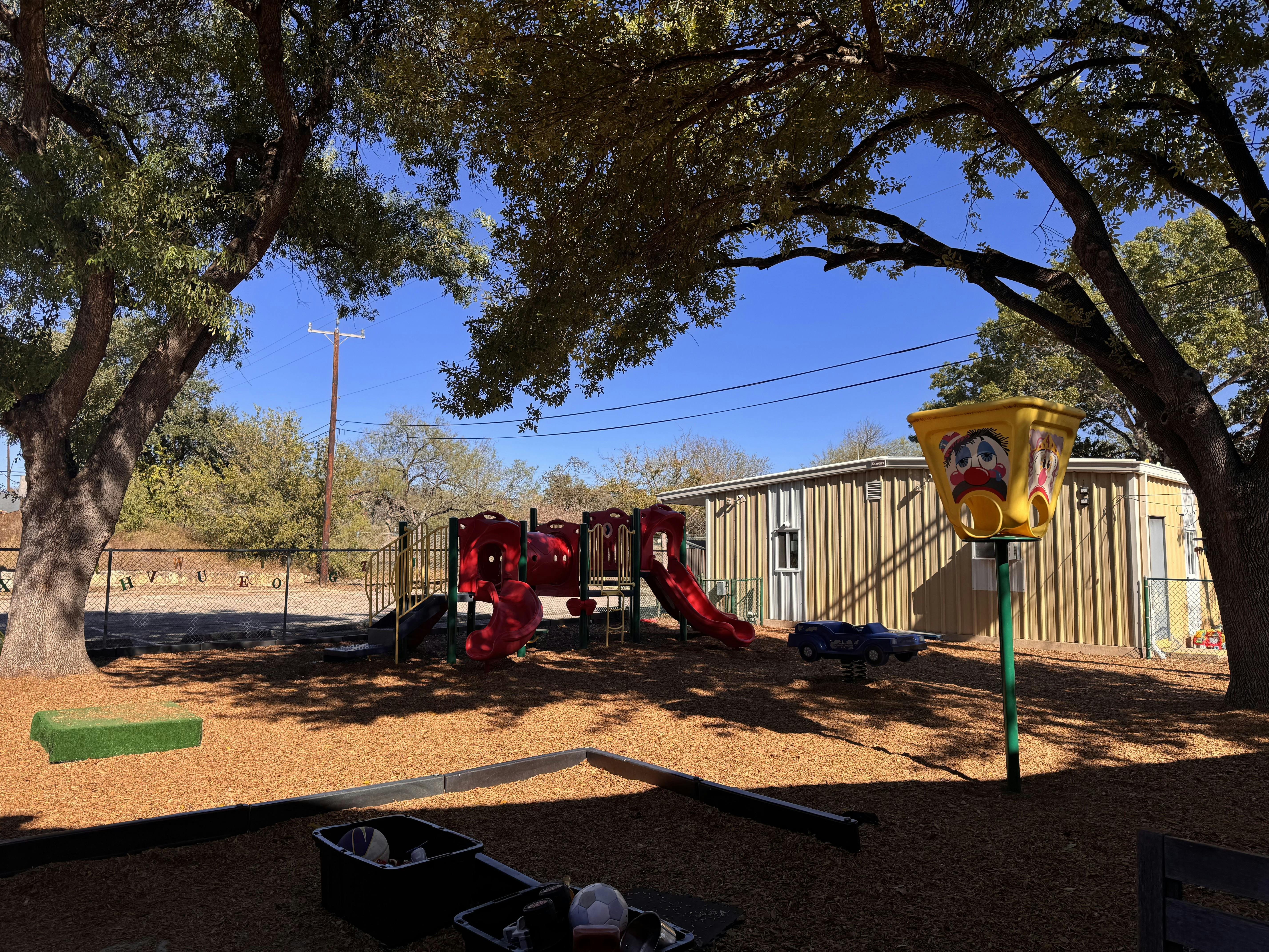 Playground equipment under large trees