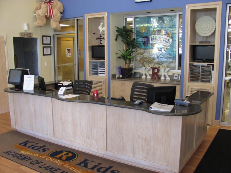 Reception desk with computers and chairs in an office