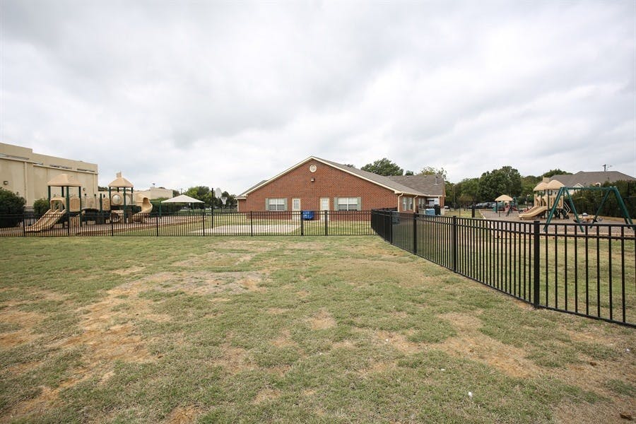 Playground with slides and swings next to a building