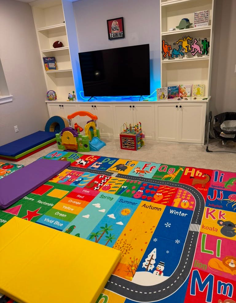Colorful educational rug with letters and seasons in a child playroom