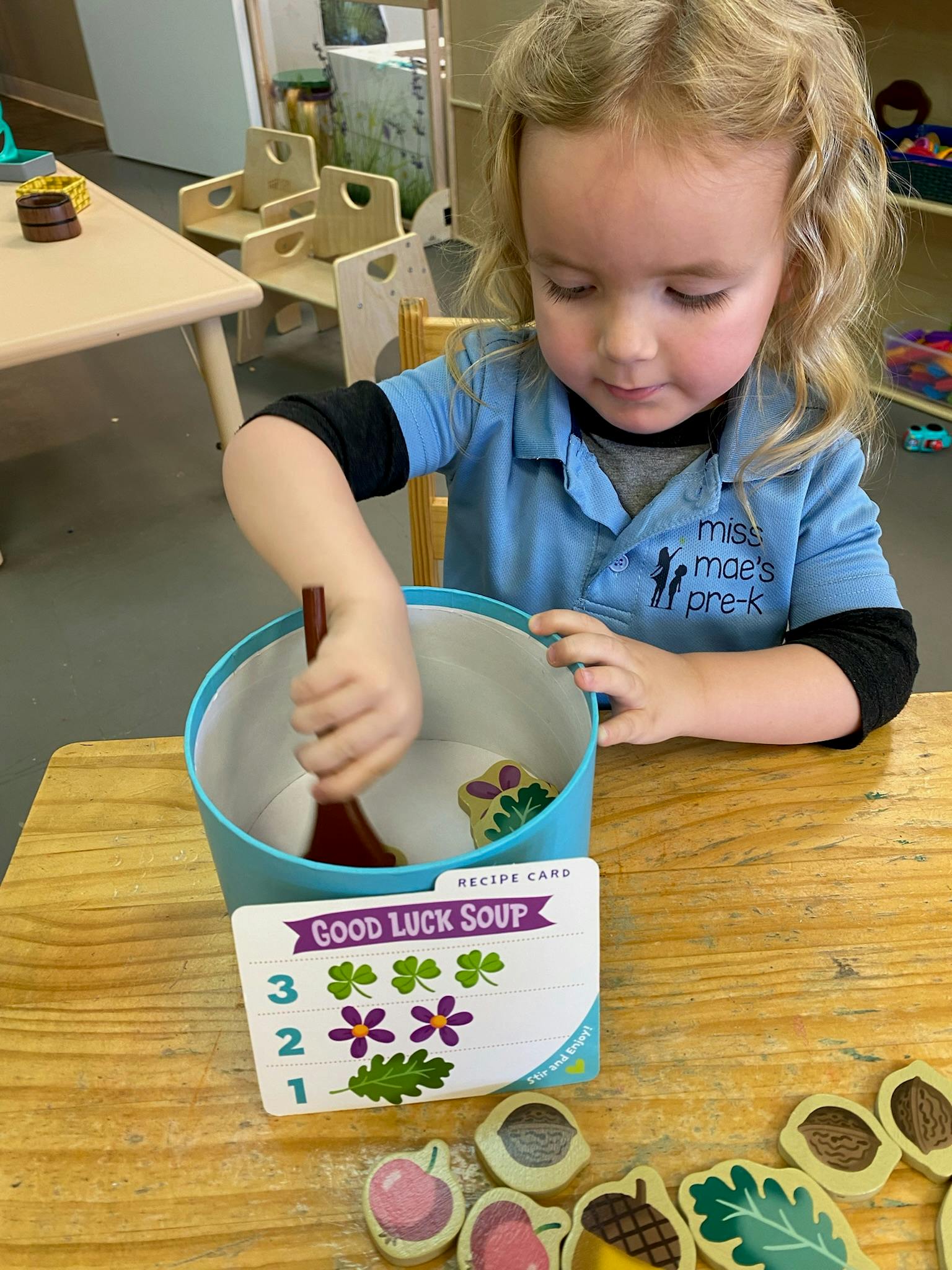 Child stirring a bowl with a wooden spoon, "Good Luck Soup" recipe card
