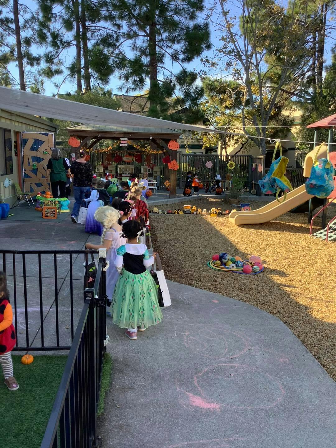 Children in Halloween costumes waiting in line outdoors