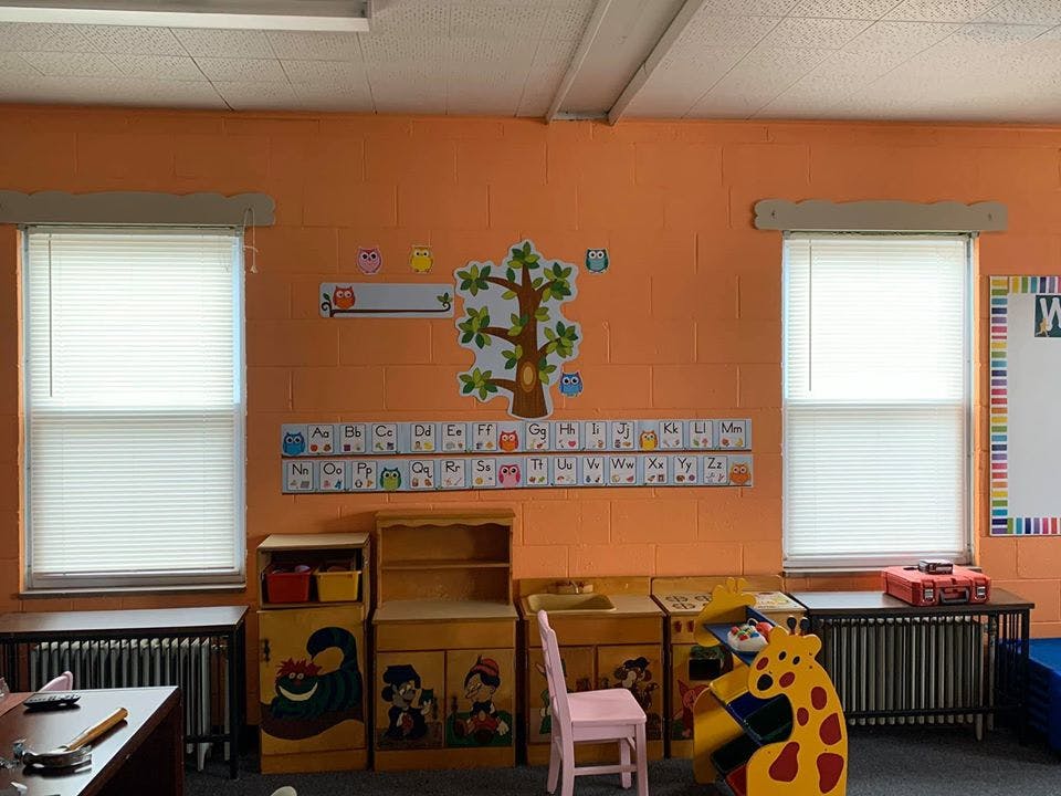 Classroom with orange walls, windows, and alphabet decorations
