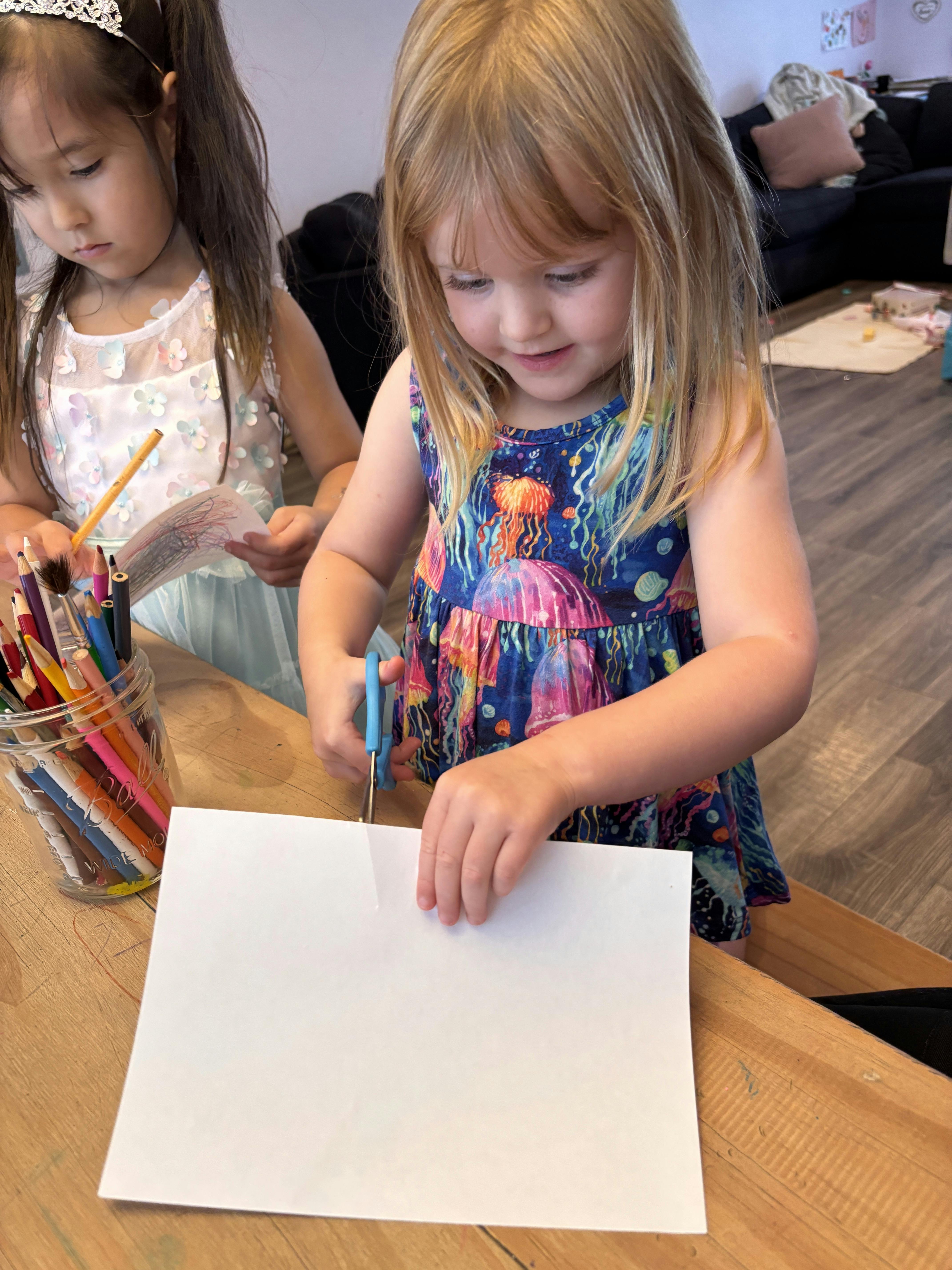 Child cutting paper with scissors
