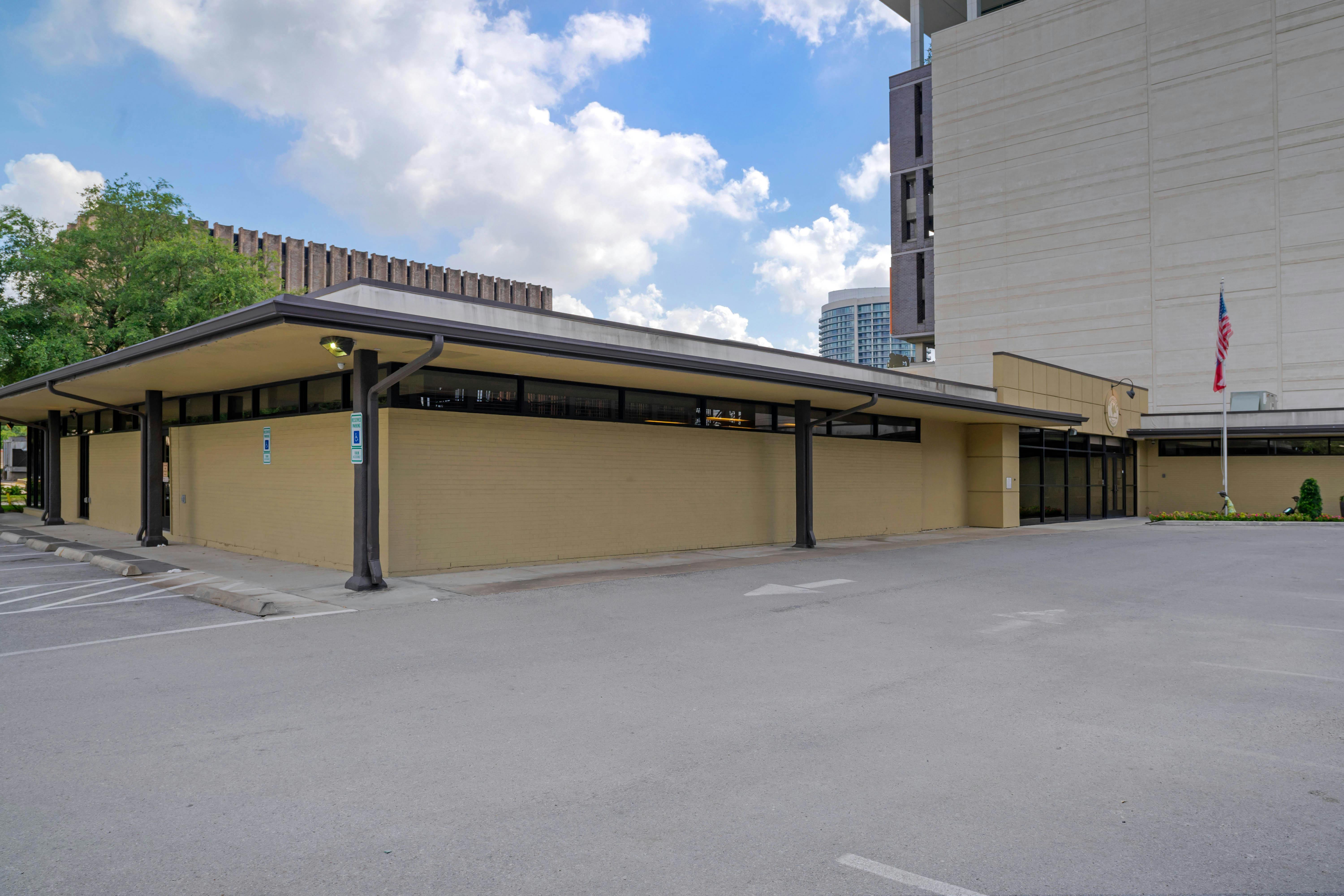 Single-story building with a covered walkway and an empty parking lot