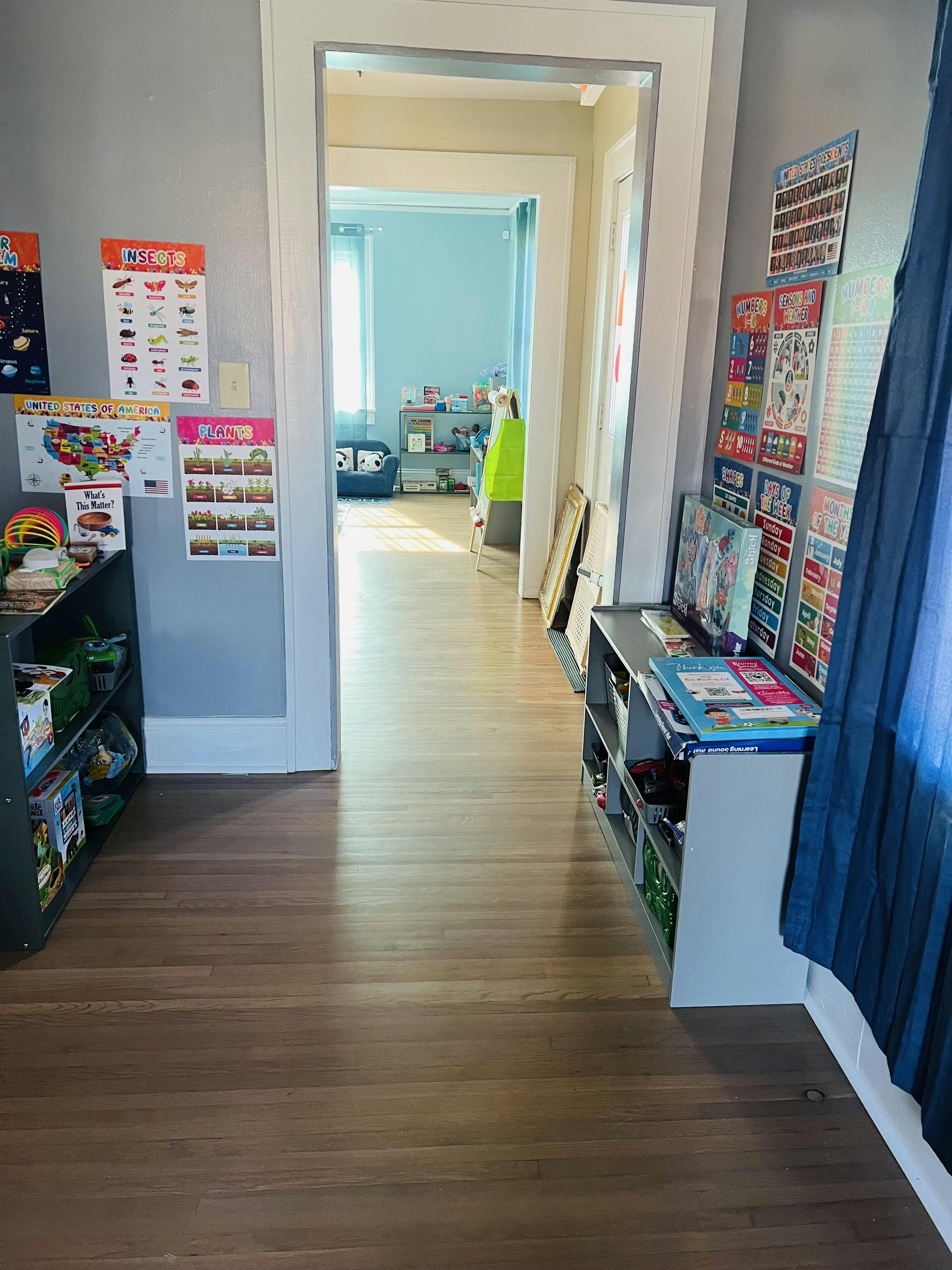 Hallway with shelves and posters on the walls