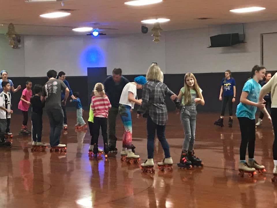 People roller skating in an indoor rink