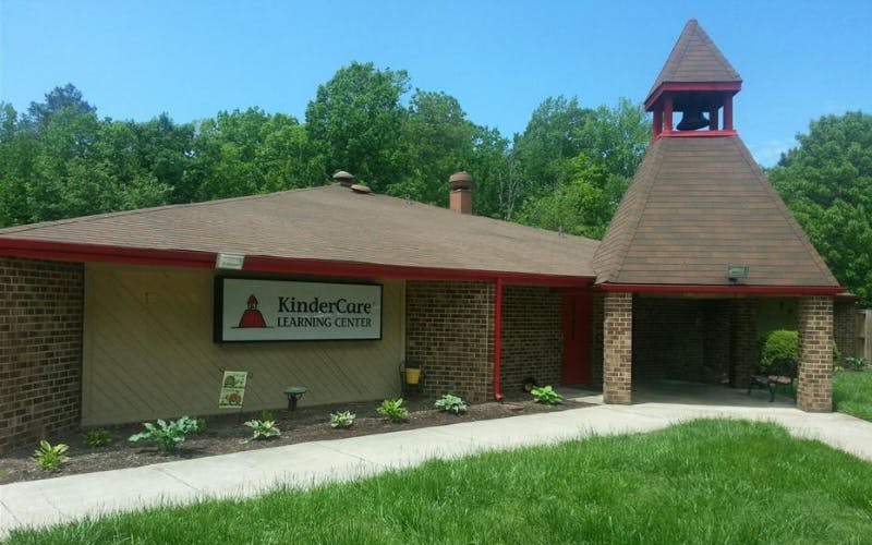 KinderCare Learning Center building exterior with a bell tower and green grass