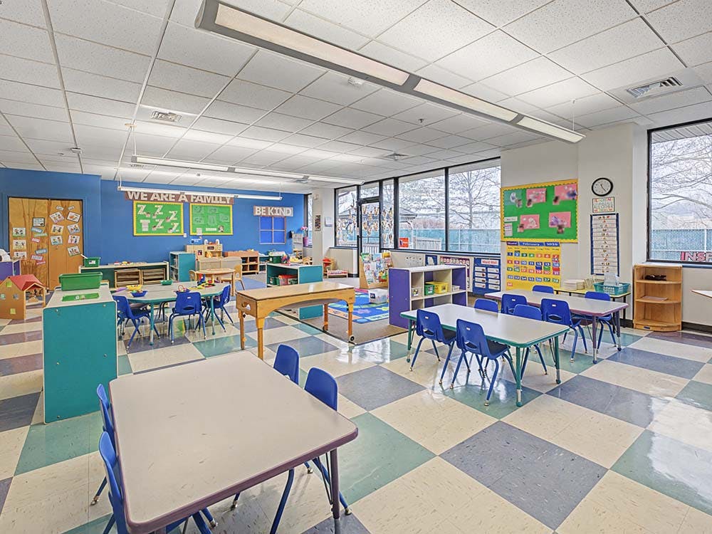Classroom with small tables and chairs, and colorful decorations