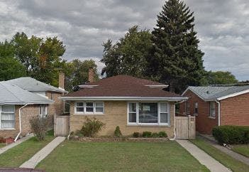Single-story house with a brown roof and a green lawn