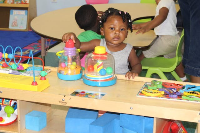 Child playing with toys at a table