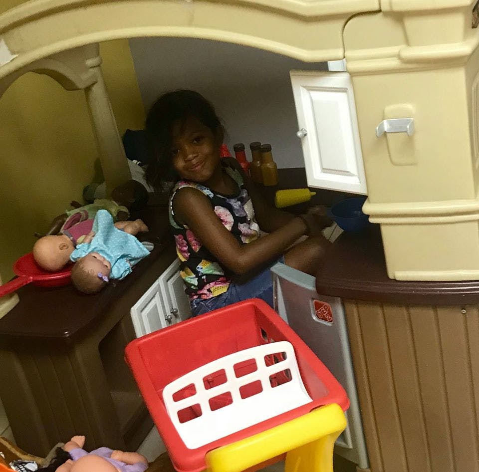 Child playing in a toy kitchen