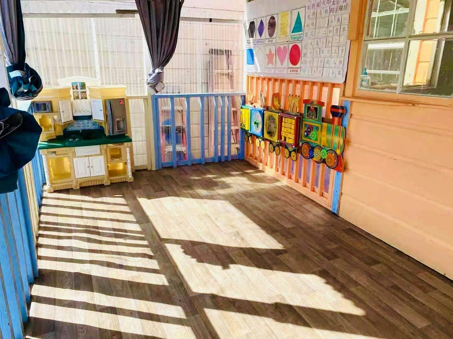 Play kitchen and toy train in a children's play area