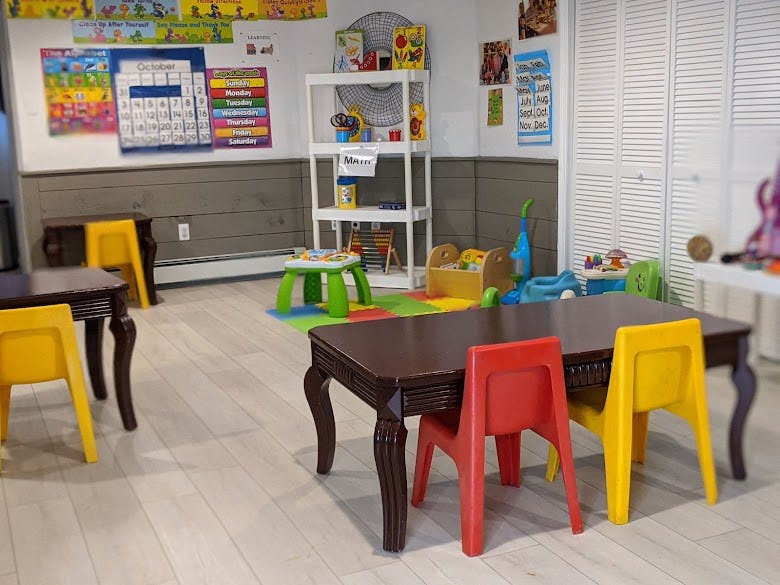 Children's play area with small tables and chairs