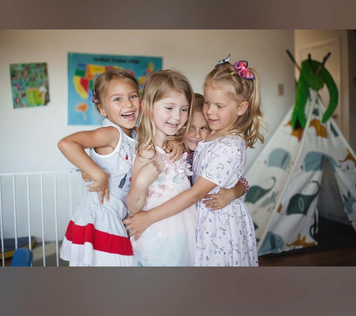 Four children hugging each other