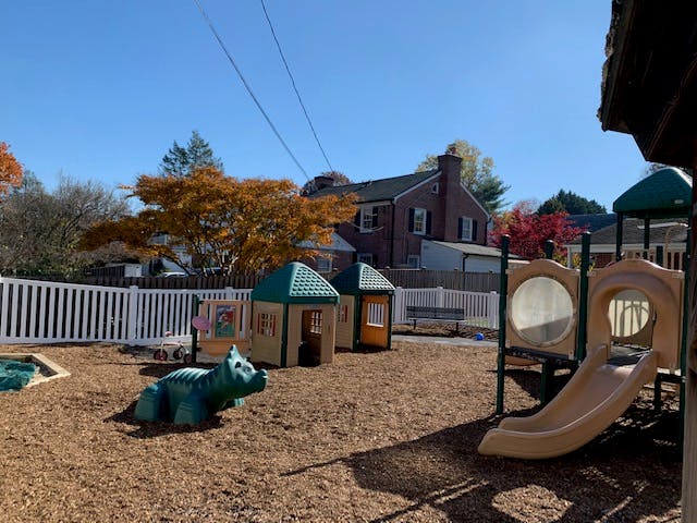 Playground with playhouses, slide, and animal spring rider