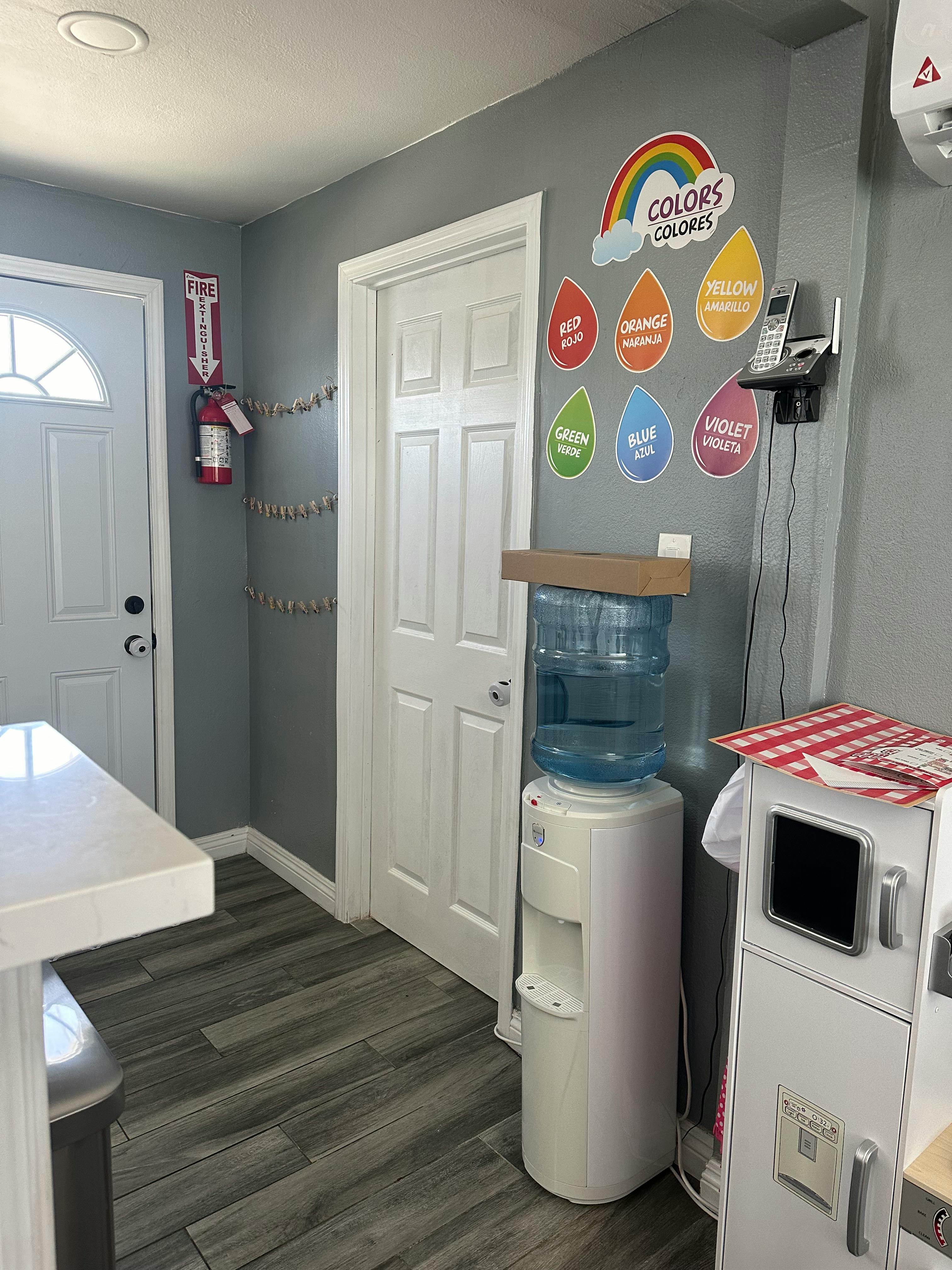 Water cooler next to a wall with color-themed decorations