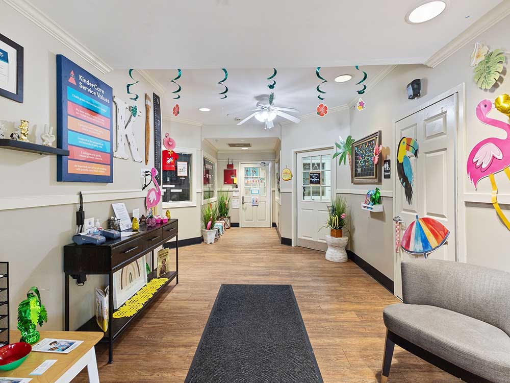 Hallway decorated with a bulletin board, desk, and tropical-themed cutouts