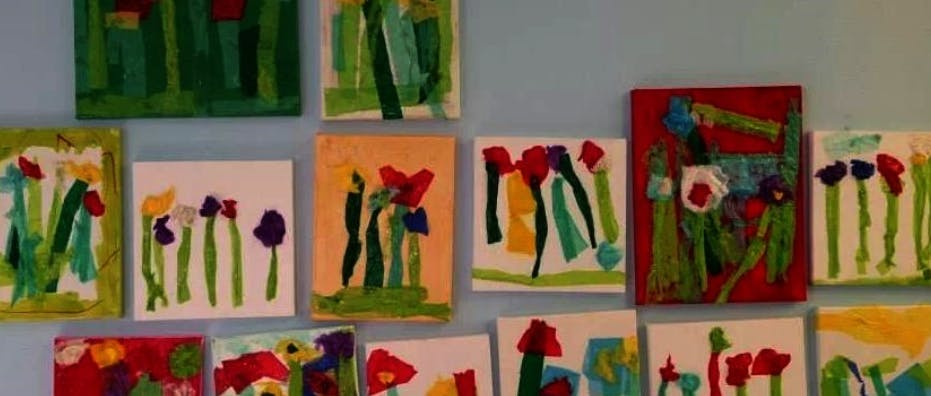 Multiple paintings of flowers on a wall