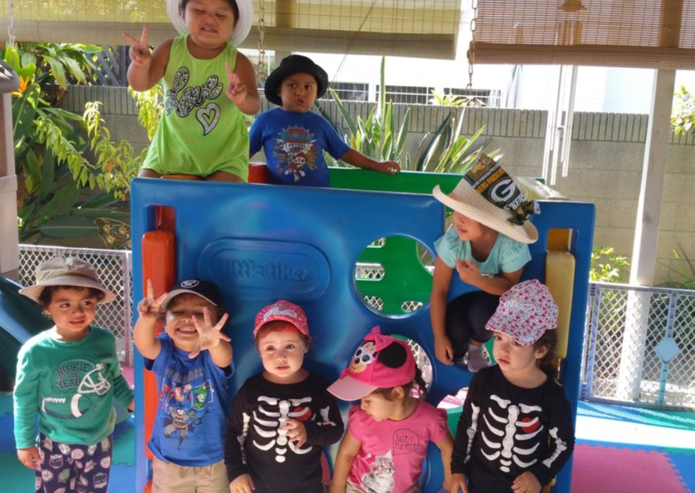 Group of children playing on a blue structure