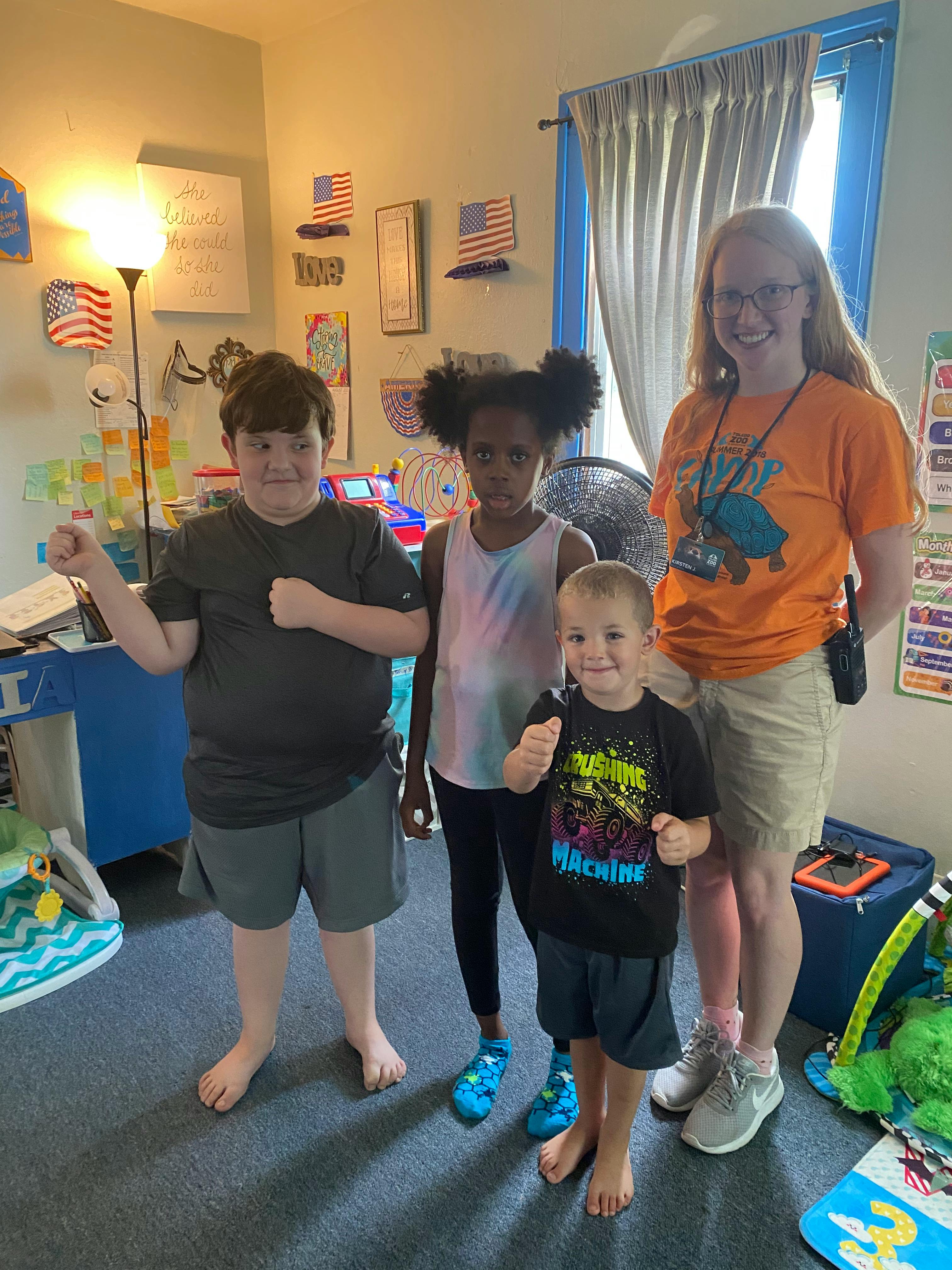 Adult and three children posing with fists raised