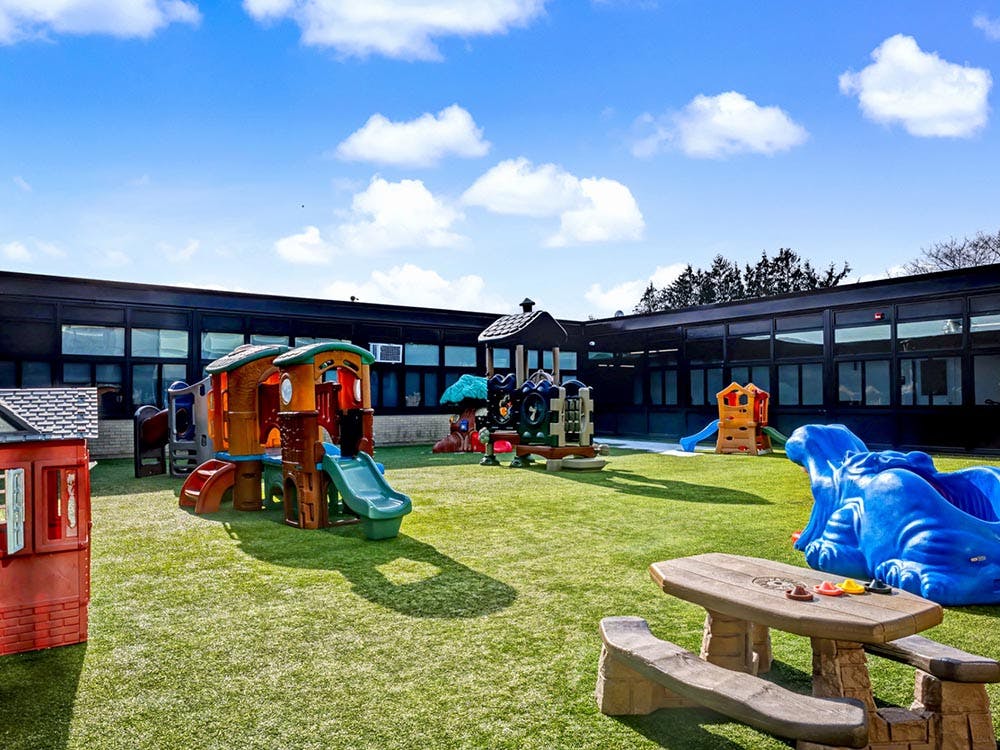 Playground with multiple play structures and a picnic table