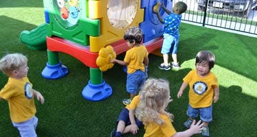 Children playing on a colorful playground structure