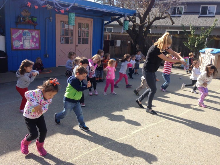 Adult and children playing outdoors