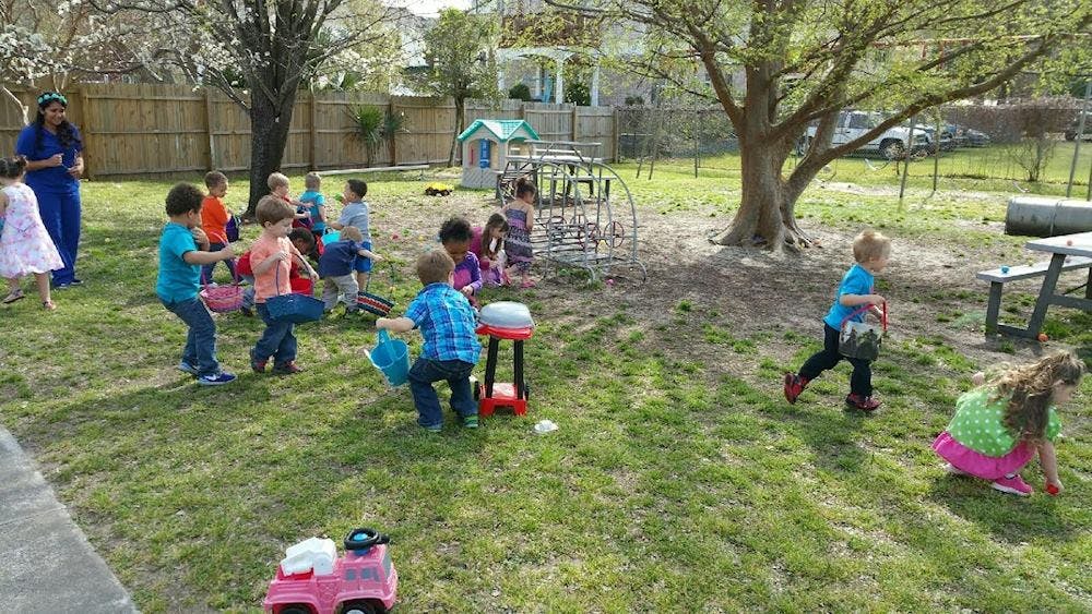 Children playing outdoors in a grassy area