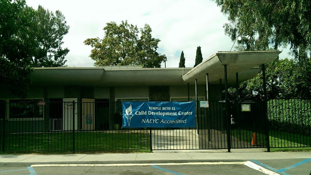 Building with a blue banner that reads "Child Development Center NAEYC Accredited"