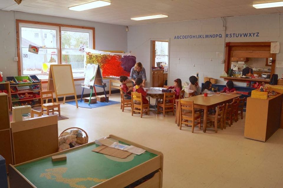 Adult and children in a classroom