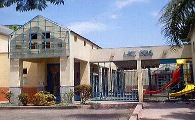 Building exterior with a glass-enclosed entrance and a playground slide