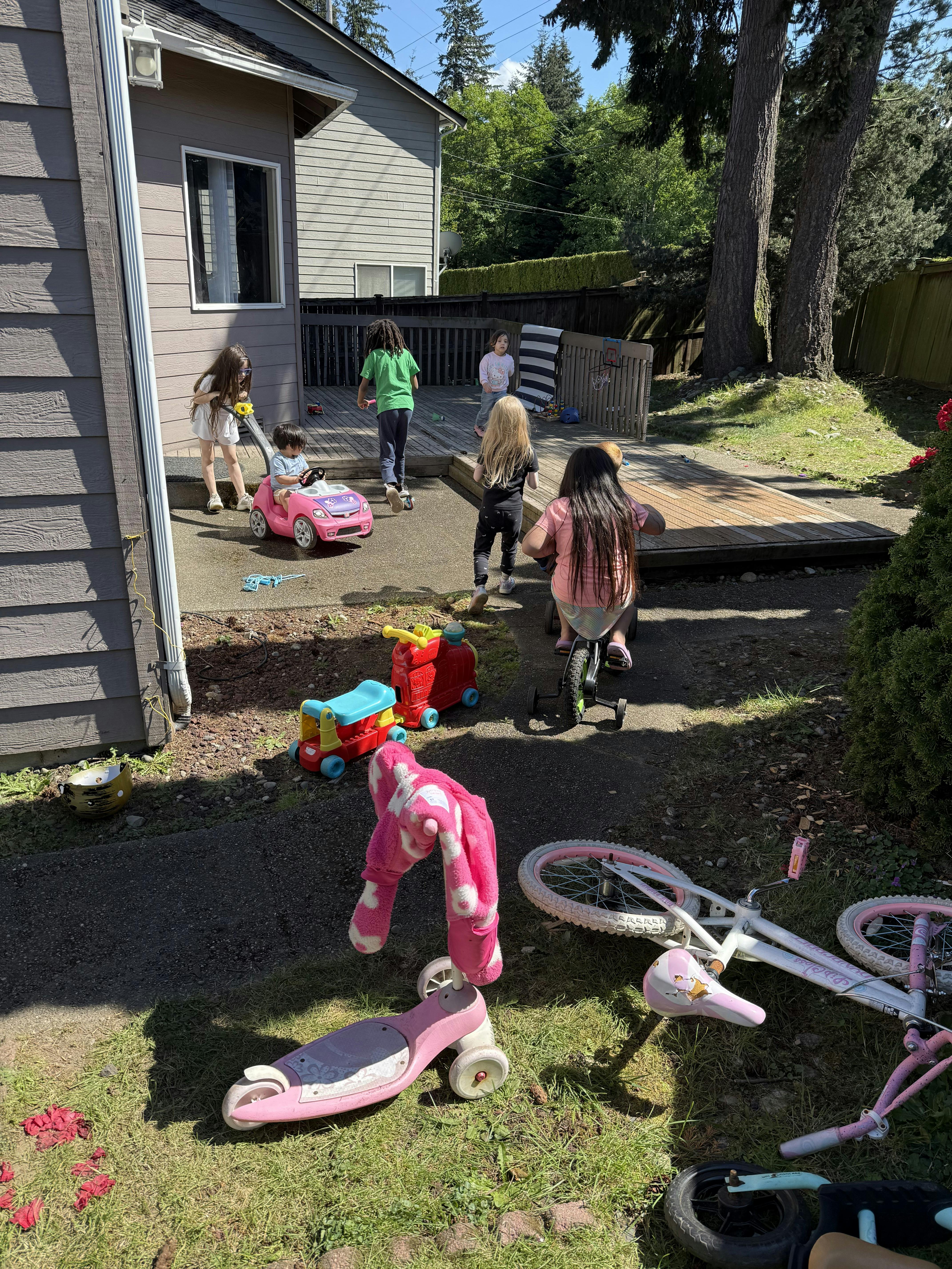 Children playing with toys in a backyard