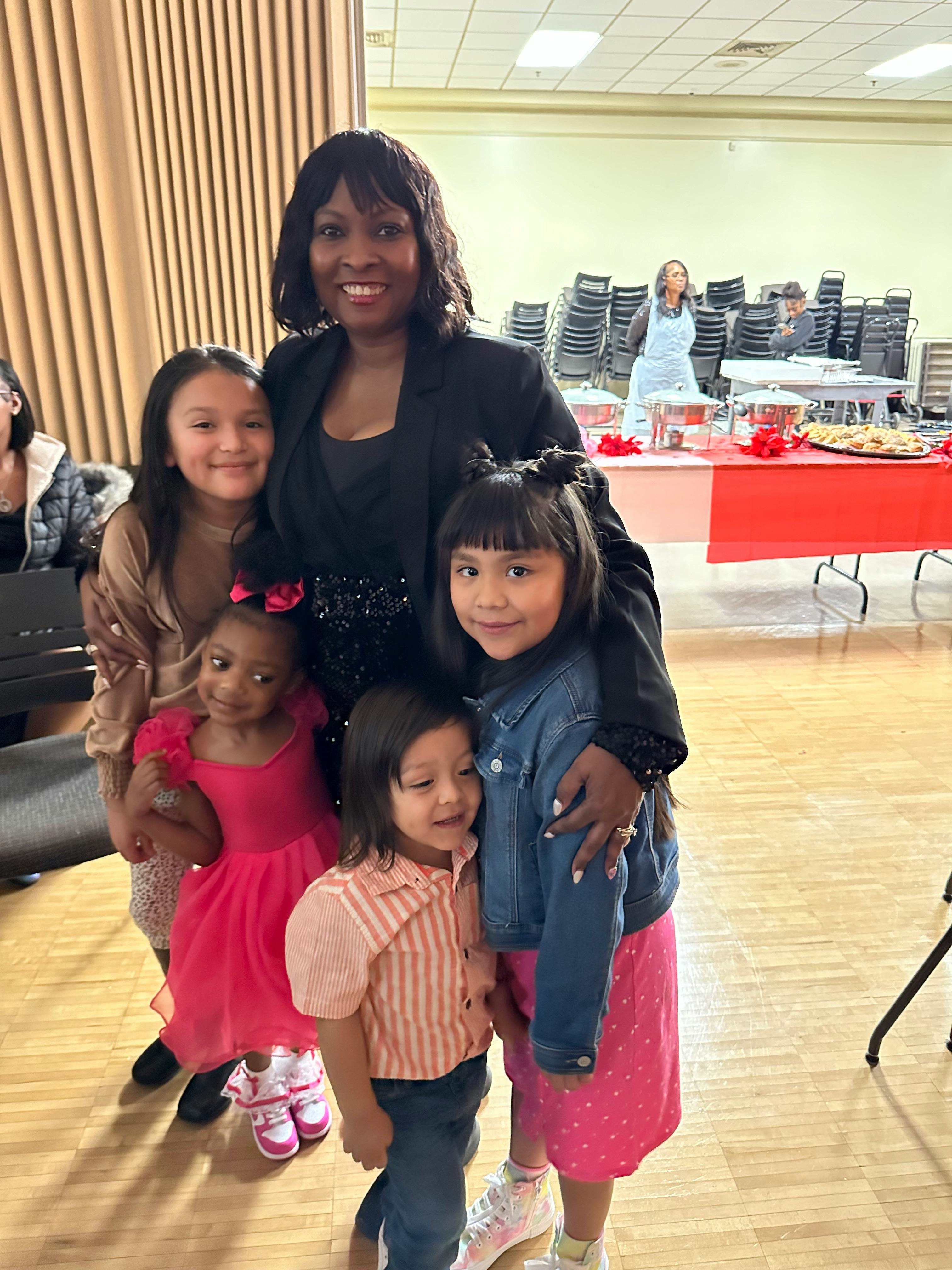 Person with four children standing together