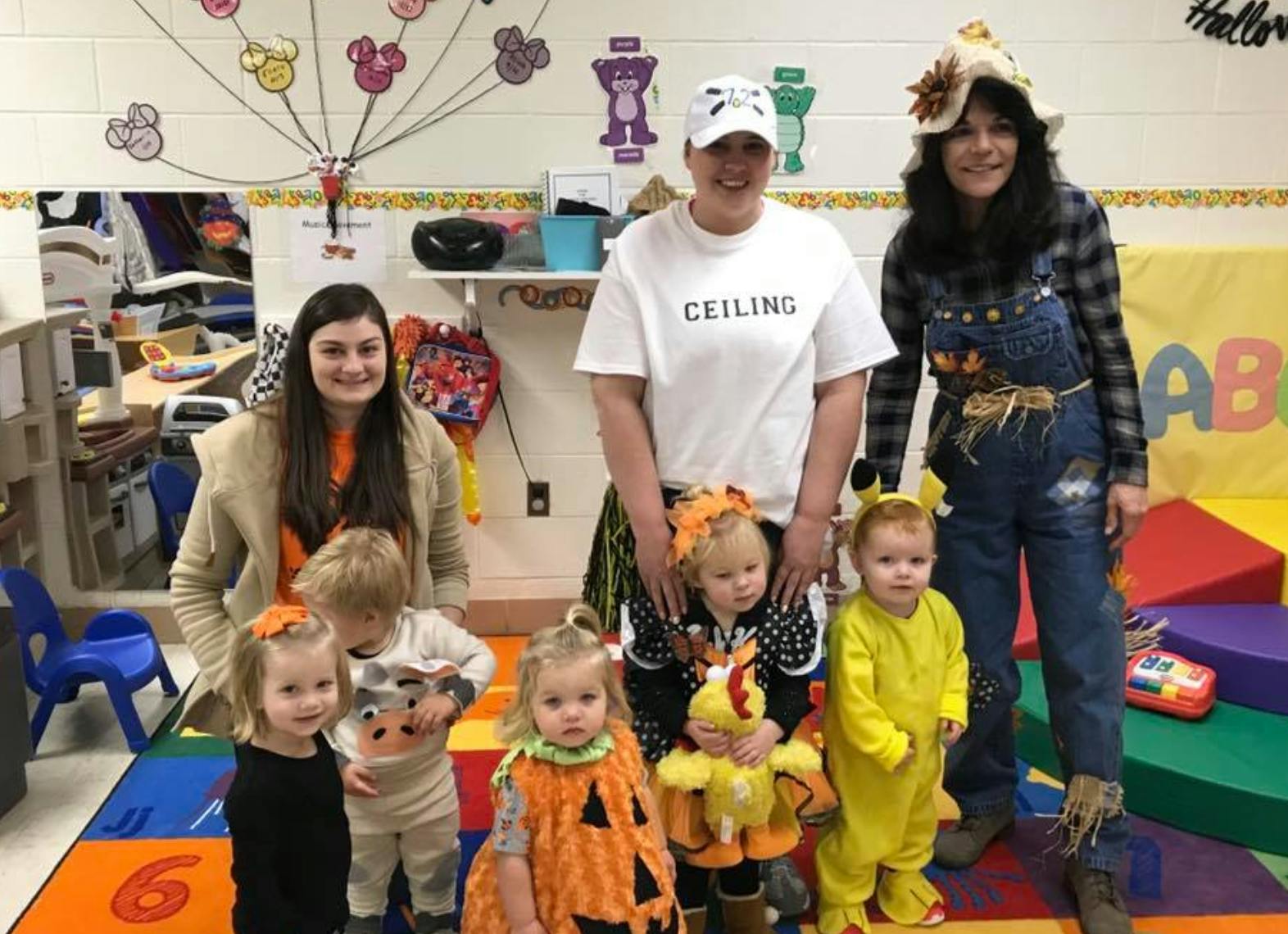 Three adults and five children in costumes