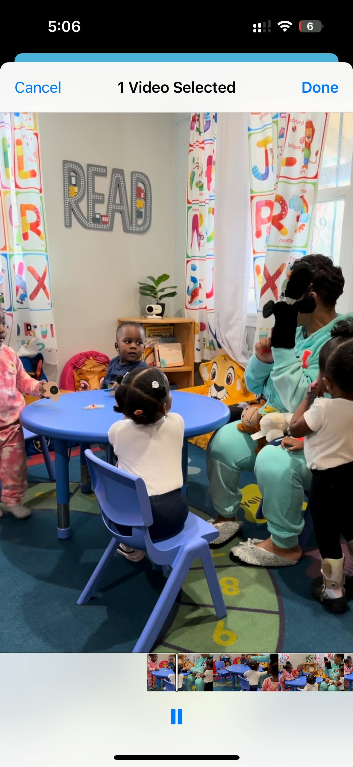 Adult with a puppet interacting with children in a classroom