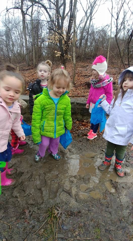 Children standing in mud outdoors