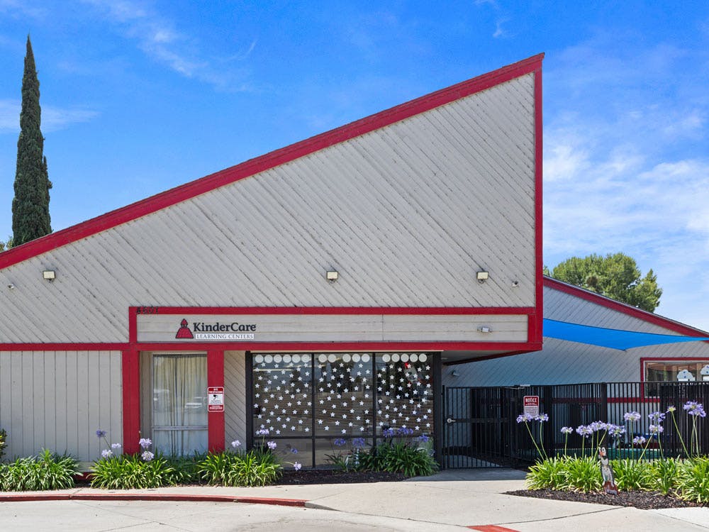 Building exterior with a sharp angled roof and "KinderCare Learning Centers" sign