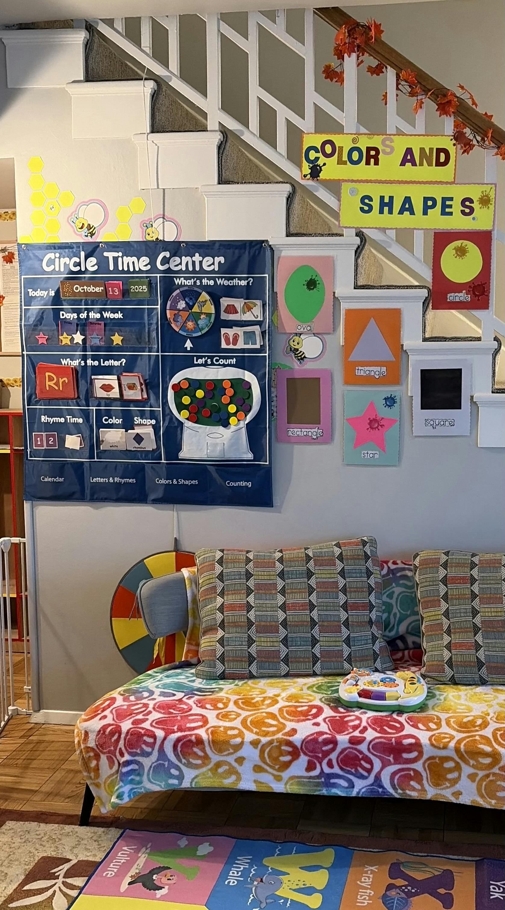 Circle Time Center chart and colorful shapes on a wall next to stairs