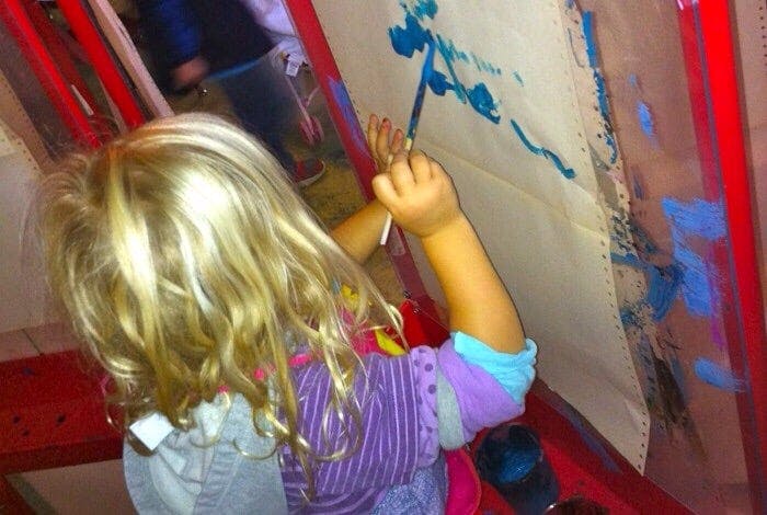 Child painting on an easel