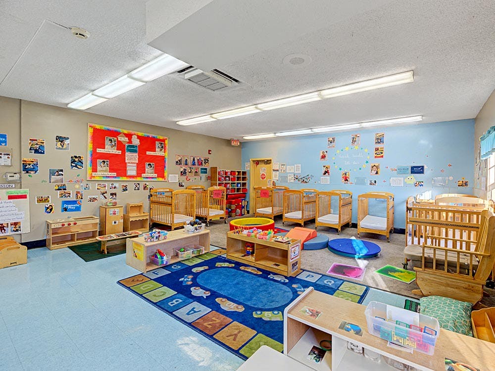 Cribs and play areas in an empty nursery classroom