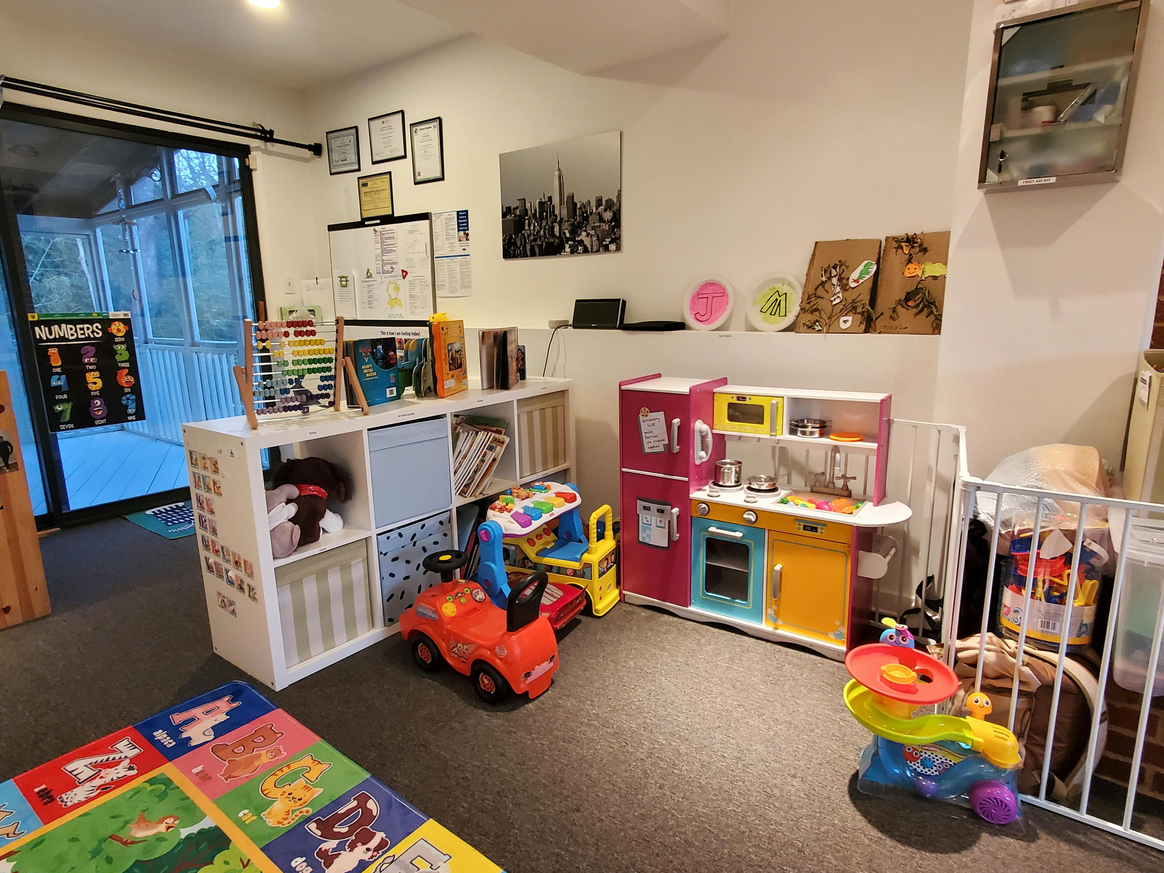 Playroom with toy kitchen, toy cars, and storage shelves
