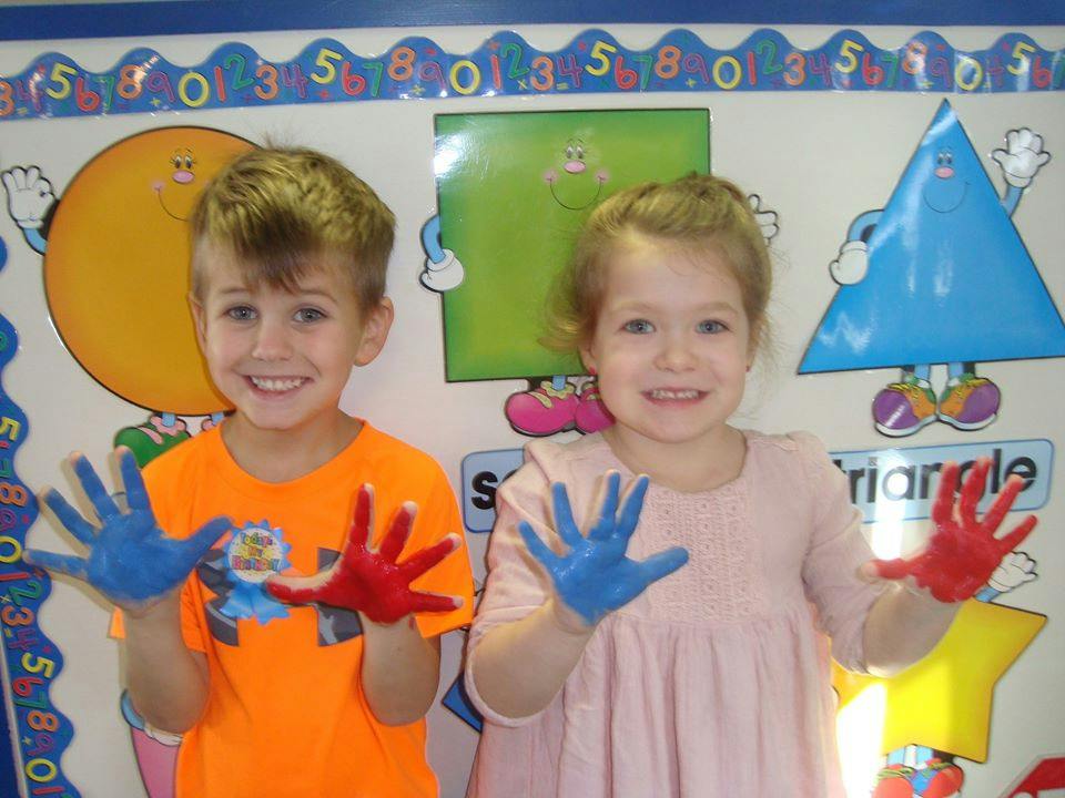 Two children with painted hands