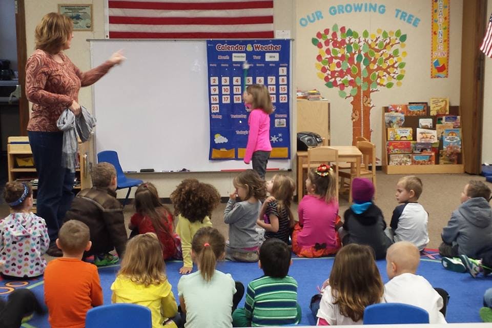 Person teaching children in a classroom