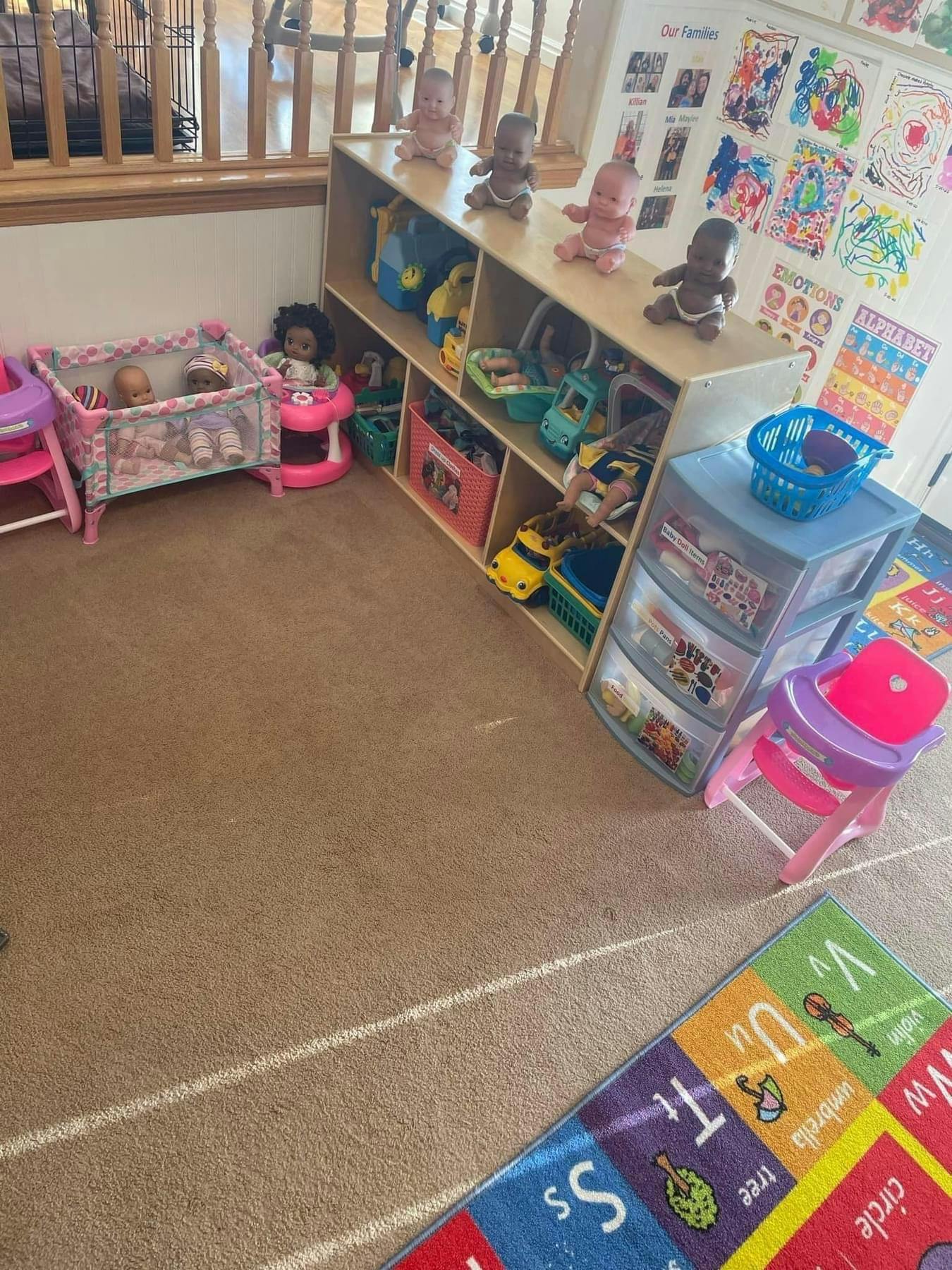 Playroom with shelves of toys, baby dolls, and a playpen