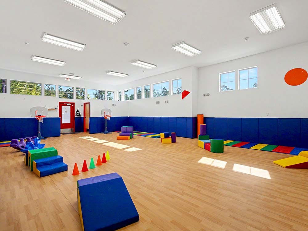 Playroom with colorful soft play equipment and small basketball hoops