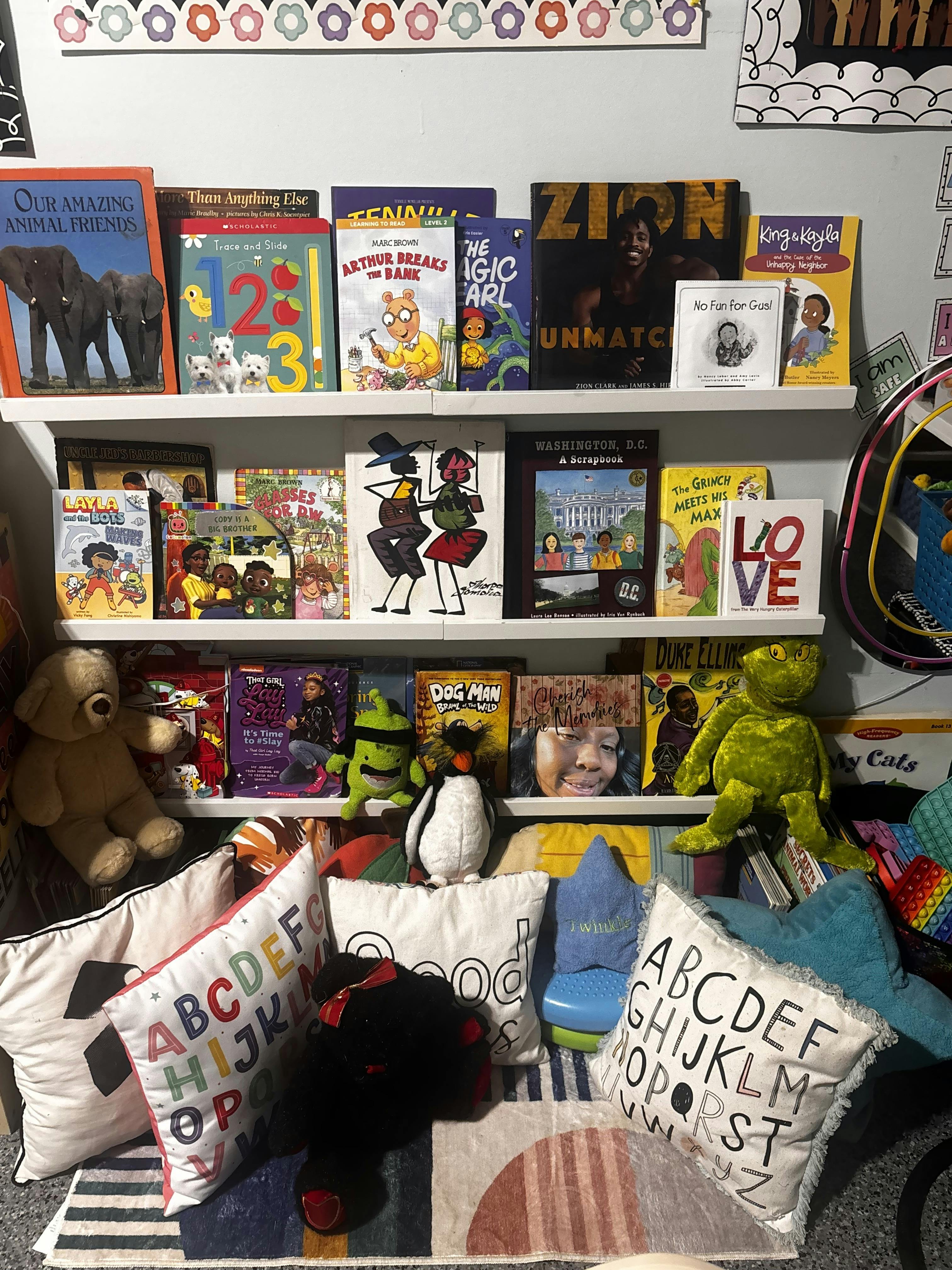 Books and stuffed animals on shelves in a classroom